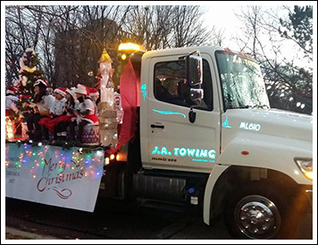 Christmas Celebrators on Back of Tow Truck