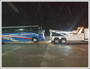 Blue Bus Being Towed